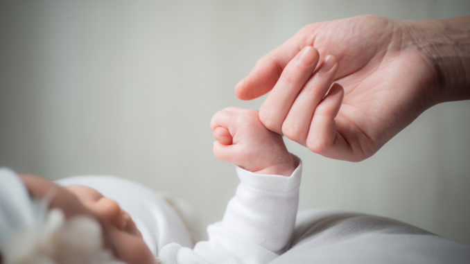 Holding Hands Cute sweet little baby keeps mom's fingers